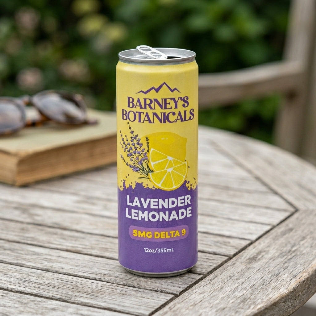 Can of Barney's Botanicals Lavender Lemonade on a wooden table with a blurred outdoor background.